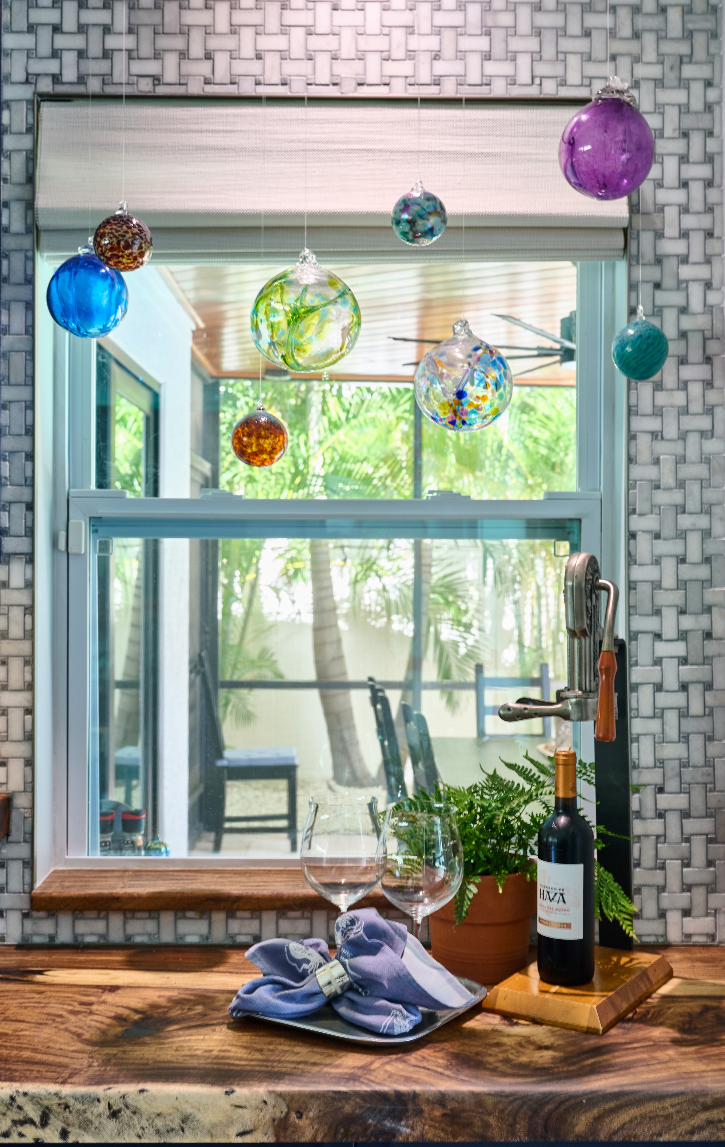Event photography — styled interior with hanging glass ornaments, wine and table setting