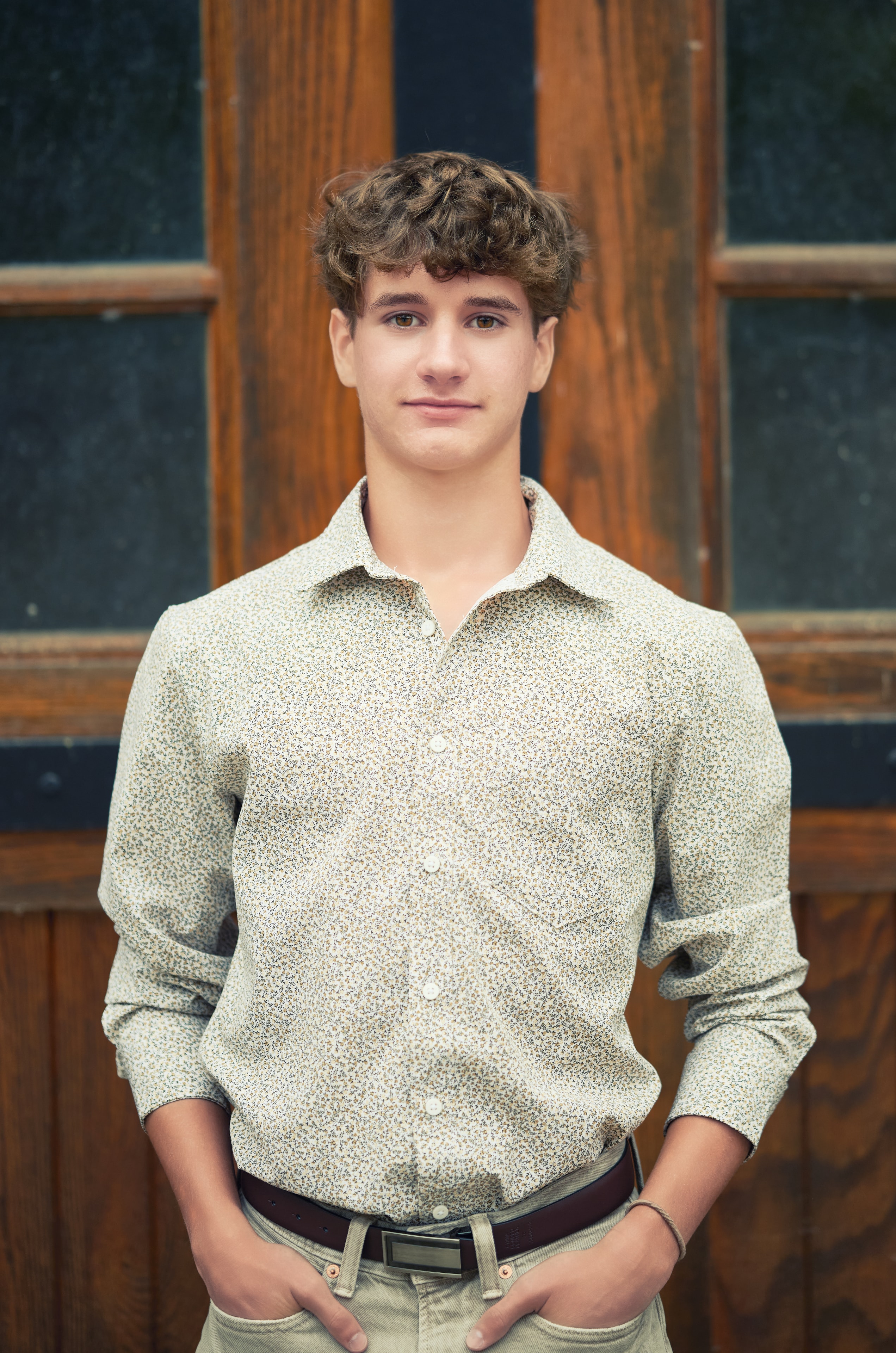 Senior portrait — young man against wooden door background